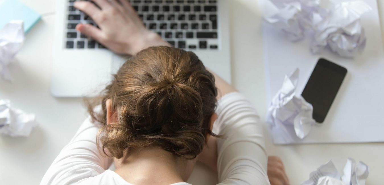 Top view portrait of a woman lying at the desk near the laptop. Education, business concept photo. Lifestyle